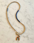 4mm 14K gold filled bead necklace with smooth lapis lazuli and oversized clasp. enamel and gold filled rainbow charm sold separately. small gold heart is clients own