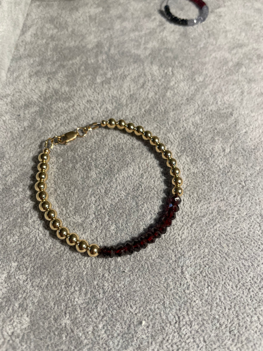 5mm 14k gold filled bracelet with band of faceted garnet and clasp.