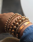 Left to right-6mm 14k gold filled with laser cut bracelet, 5mm 14k gold filled bracelet with rondelles, 8mm 14k gold filled bracelet, 10mm 14k gold filled bracelet, 4mm 14k gold filled stardust beads with spaced smooth beads, clients own.