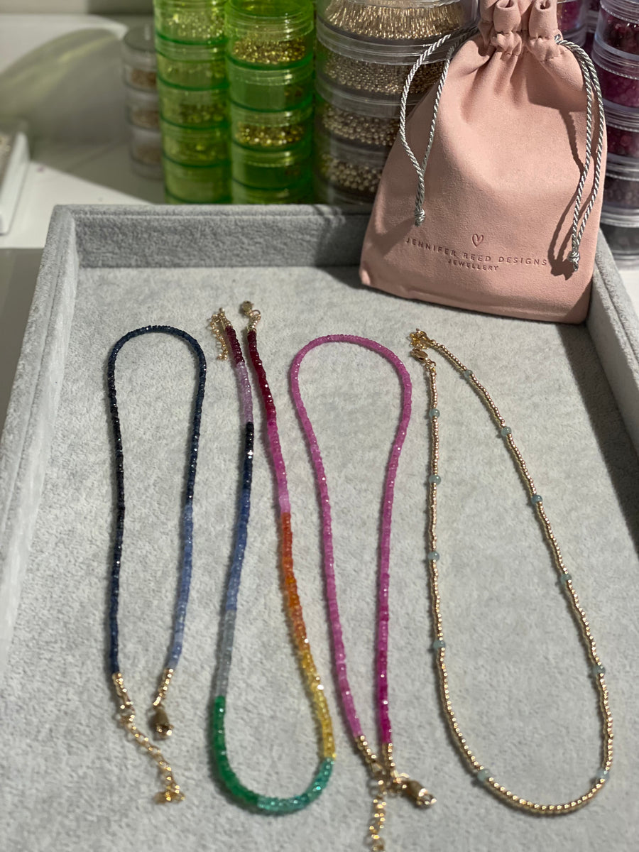 Left to right - all navy sapphire, large multi stone rainbow "Tisissi", pink ruby and petite gold filled beads with smooth aquamarine.