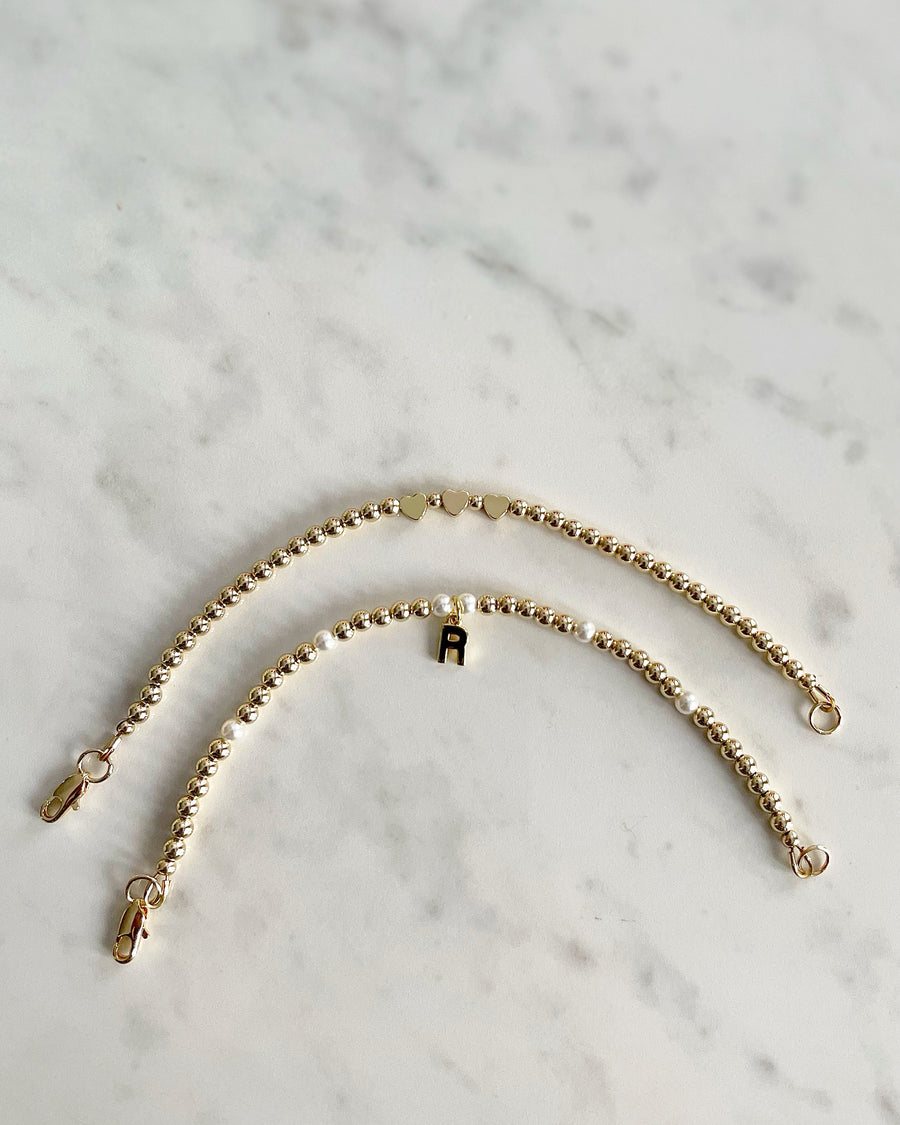 3mm 14k gold filled bracelet with three hearts and clasp and 3mm 14k gold filled bracelet with small pearls, "R" initial charm and clasp. 