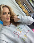 Alison Fiorini of Jordana's Rainbows in her tutti sweatshirt and gemstone necklace with amethyst hand carved cloud charm.