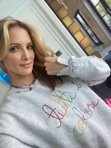 Alison Fiorini of Jordana's Rainbows in her tutti sweatshirt and gemstone necklace with amethyst hand carved cloud charm.